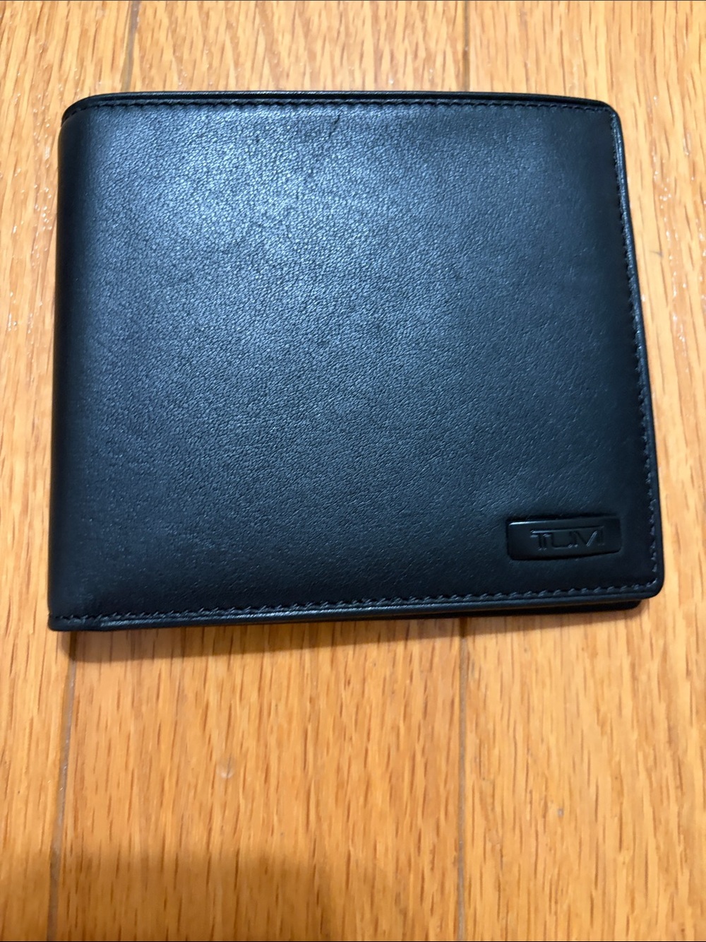 Tumi Black Leather Hipster leather Wallet with metal ornament